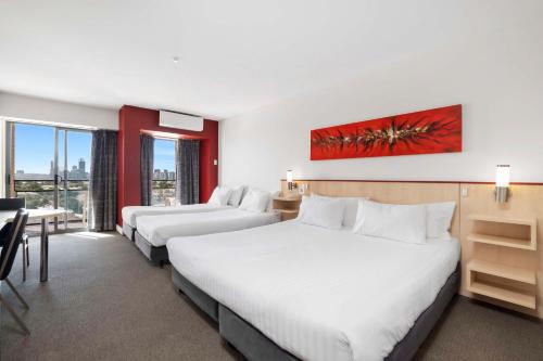 A bed or beds in a room at Metro Hotel Perth