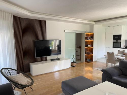 sala de estar con TV de pantalla plana en la pared en House and pool BajNa, en Mostar