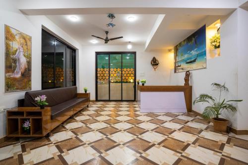 a lobby with a couch and a checkerboard floor at Thomson Imperial Boutique G0A in Calangute