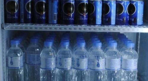 a bunch of bottles of water on a shelf at K.S Hotel in Cheonan