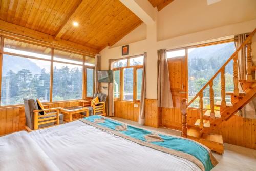 a bedroom with a bed in a room with windows at Hide-in Old Manali in Manāli