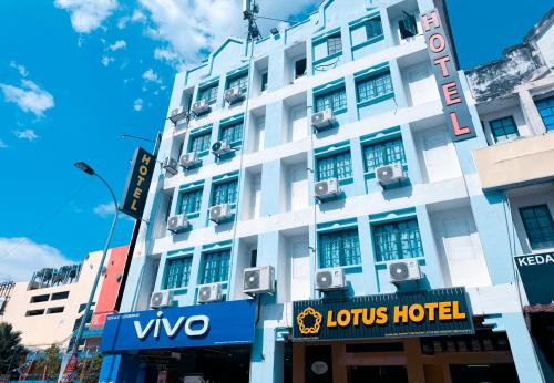 a white building with a sign in front of it at Sun Inns Seremban Formerly known as Lotus Seremban in Seremban