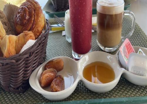 a table with a cup of tea and a basket of pastries at Luxury Qurtuba in Nouakchott