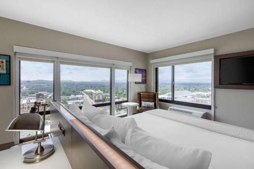 A bed or beds in a room at Cambria Hotel Downtown Asheville