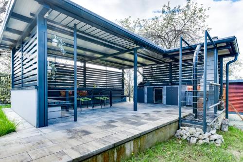 a kitchen and dining area of a house with a pergola at Relax house MAROKIS in Karlovac