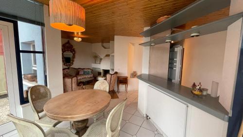 a kitchen and dining room with a table and chairs at Lakeside-Apartment-2 Appartement avec une grande terrasse et vue panoramique sur le lac in Vevey