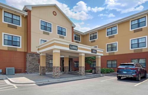 a hotel with a car parked in a parking lot at Extended Stay America Select Suites - Chicago - O'Hare in Rosemont