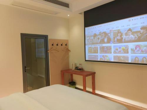 a bedroom with a large projection screen on the wall at Flower Whisperer Homestay in Zhangjiajie