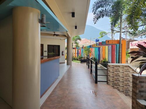 an empty hallway of a building with colorful buildings at Inngo Tourist Inn in El Nido