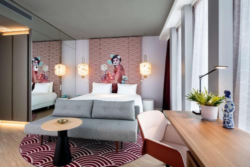 um quarto de hotel com uma cama e um sofá em nhow Amsterdam Rai em Amesterdão