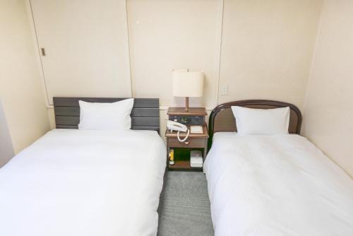 Tempat tidur dalam kamar di Hotel Alpha Inn Akita - Vacation STAY 67286v