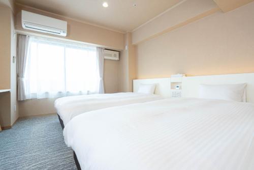 Tempat tidur dalam kamar di Hotel Alpha Inn Akita - Vacation STAY 67288v