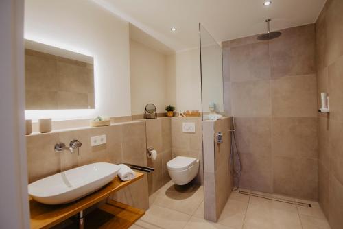 a bathroom with a sink and a toilet and a shower at Hotel-Restaurant Haselhoff in Coesfeld