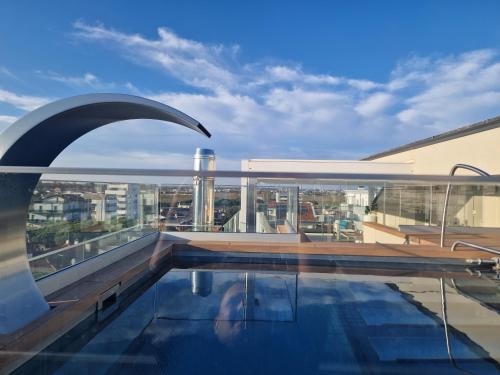 a swimming pool on the roof of a building at Almalux Jesolo Wellness & Spa 3 stelle superior in Lido di Jesolo