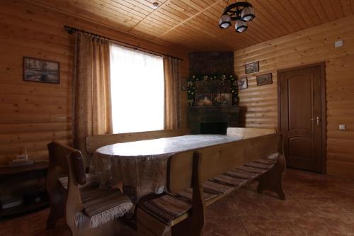 a dining room with a table and a window at Proskurov Holiday Home in Bukovel