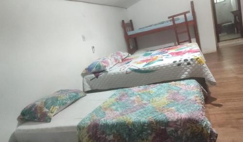 A bed or beds in a room at Oncotô Palmas Hostel