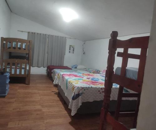 A bed or beds in a room at Oncotô Palmas Hostel