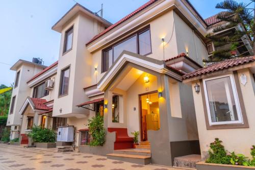 バガにあるCalangute Candolim Beach Bay villas and Apartmentsの玄関と階段のある白い家