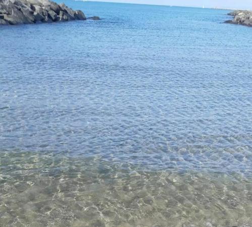 a large body of water with rocks in it at Sweet Home FCO Airport Roma in Fiumicino