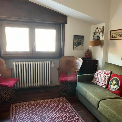 a living room with a couch and a chair at appartamento Cervinia fronte Funivie in Breuil-Cervinia