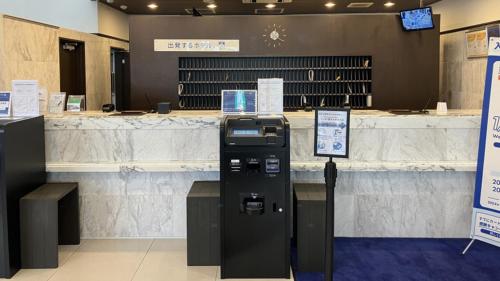 a ticket machine in front of a counter in a store at Toyoko Inn Kitakami eki Shinkansen guchi in Kitakami