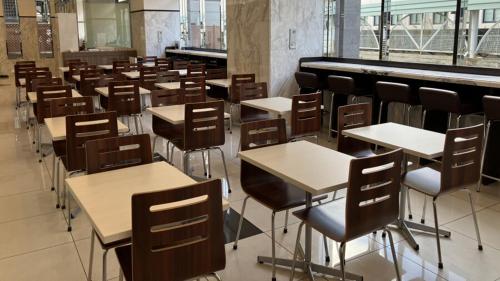 an empty classroom with desks and chairs in it at Toyoko Inn Kitakami eki Shinkansen guchi in Kitakami