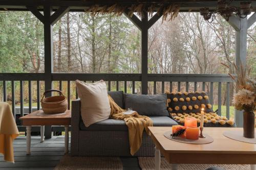 a porch with a couch and a table at Auberge Old Chelsea in Chelsea