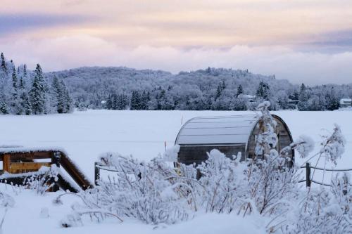 a barn covered in snow in a field at Estérel Resort in Esterel