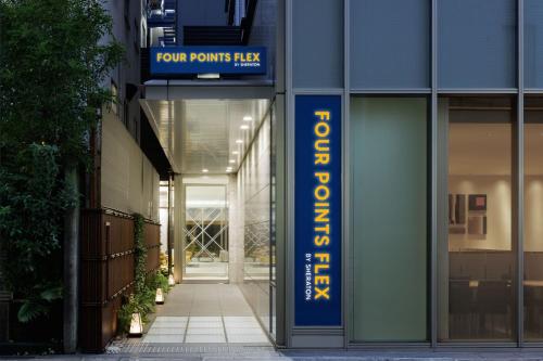 an entrance to a building with a sign that reads four points plaza at Four Points Flex by Sheraton Osaka Umeda in Osaka