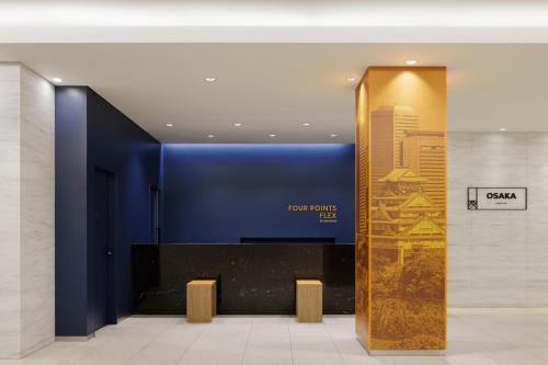 a lobby with a sign for the colgate hotel at Four Points Flex by Sheraton Osaka Umeda in Osaka