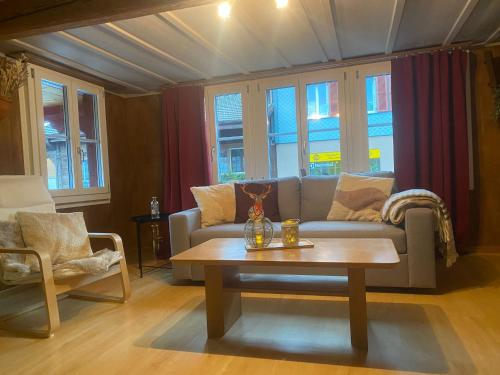 a living room with a couch and a coffee table at Cosy apartment in heritage protected swiss chalet in Matten