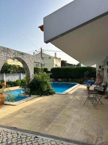 a patio with a swimming pool in a house at MAR VERDE - Parede-Cascais in Parede