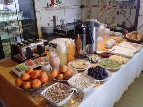 a counter with many plates of food on it at ANDENES DEL TITICACA in Puno