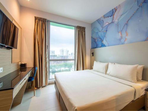 Tempat tidur dalam kamar di ibis Styles Singapore Albert