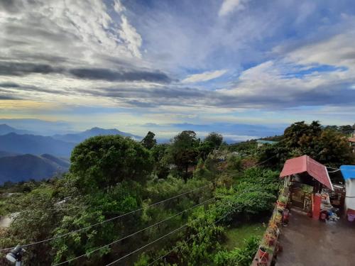 uitzicht op een heuvel met bergen op de achtergrond bij MISBHA HomeStay in Kodaikānāl