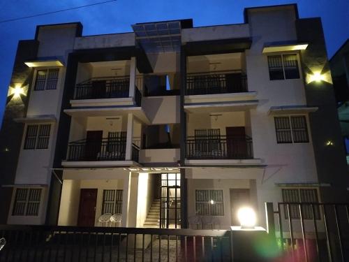 a white building with balconies on the side of it at Wild Part in Sultan Bathery