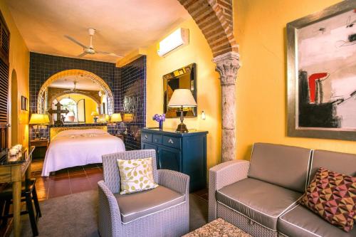 a bedroom with a bed and a table and chairs at Quinta Maria Cortez in Puerto Vallarta