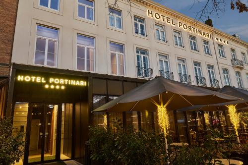 a hotel with an umbrella in front of a building at Hotel Portinari in Bruges