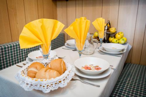 a table with plates and bowls of bread on it at Villaggio Turistico Camping Cervino in Antey-Saint-André