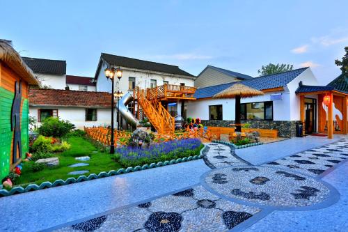 a house with a garden and a playground at Shanghai Chuxin Moshe B&B Disney Store in Shanghai