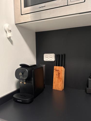 a kitchen counter with a coffee maker and a microwave at A pie de PLAYA in La Pineda