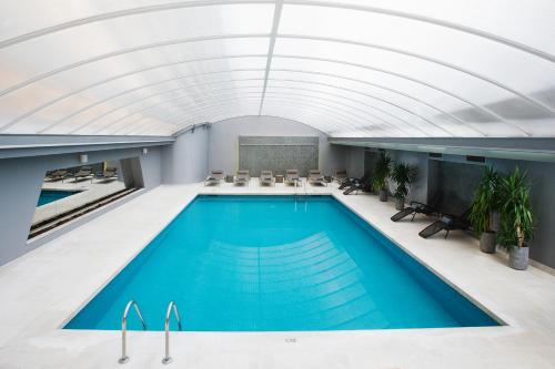 una piscina cubierta con techo abovedado en Altis Grand Hotel, en Lisboa