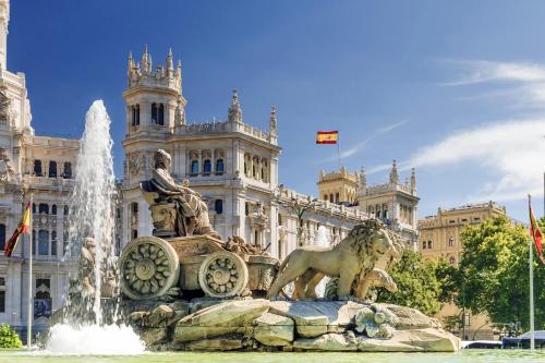 une fontaine en face d'un grand bâtiment dans l'établissement Hostel Las Rosas, à Madrid