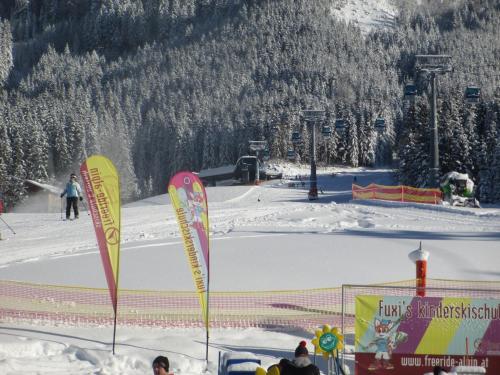 deux drapeaux dans la neige sur une piste de ski dans l'établissement Ferienhaus Schwarzenbacher, à Lungötz