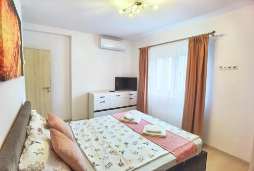 a small bedroom with a bed and a television at Exclusive Apartment SIBIU in Sibiu