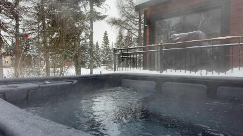 Le Bora Nature - Calm Relaxation VIP Escape في Valcartier Station: تجمع المياه امام المنزل في الثلج