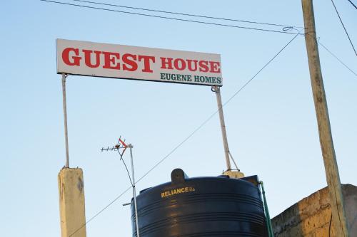 a sign for a guest house on top of a barrel at EUGENE HOMES Guest House in Gilgil