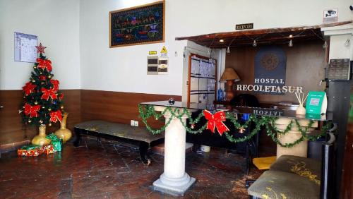 uma sala de estar com uma árvore de Natal e um piano em Hostal Recoleta Sur em Sucre