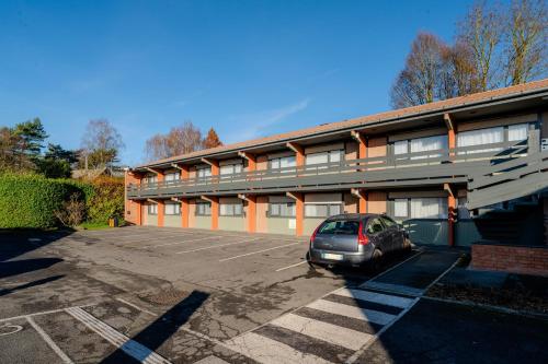 a car parked in a parking lot in front of a building at Campanile Lille Est - Villeneuve D'ascq in Villeneuve d'Ascq