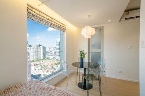 a bedroom with a table and a large window at Shanghai Yi Du B&B - Near Nanjing West Road commercial district, 350 walk from the Natural History Museum subway in Shanghai